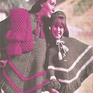 May include: Two women wearing crocheted ponchos, hats, and scarves. The woman on the left is wearing a green poncho with a pink crocheted scarf and hat. The woman on the right is wearing a green poncho with a white crocheted trim and a pink crocheted beret. The image includes the text "Poncho, Hat, Beret & Scarf" and "AD37".