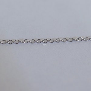 May include: A silver chain necklace with a delicate, linked design.