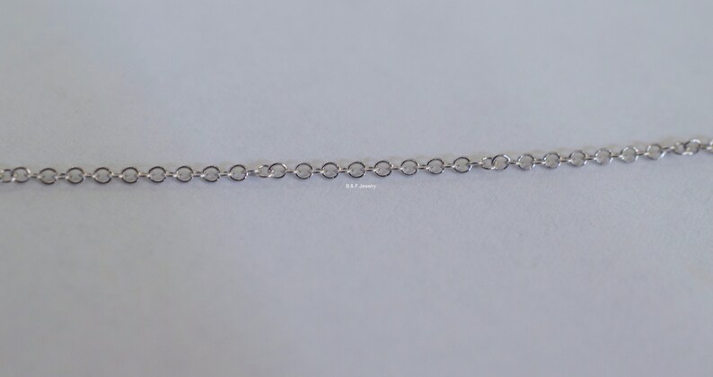 May include: A silver chain necklace with a delicate, linked design.