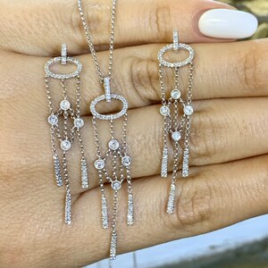 14kt White Gold Modern Diamond Drop Earrings And Matching Pendant.