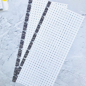 May include: Three white planner pages with black and gold patterned edges. The pages are decorated with a blue polka dot pattern.