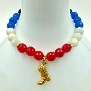 May include: Red, white and blue beaded bracelet with a gold cowboy boot charm.
