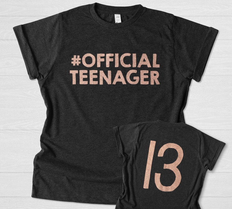 May include: A black t-shirt with the text "#OFFICIAL TEENAGER" in rose gold lettering. A second black t-shirt with the number "13" in rose gold lettering.