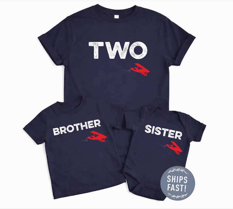 May include: Navy blue t-shirts and a onesie with white text and a red airplane graphic. The shirts say "TWO", "BROTHER", and "SISTER". The onesie has a "SHIPS FAST!" sticker.