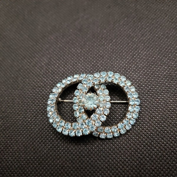 Double Circle Brooch Features Silver Metal and Light Blue Faceted Glass Stones - Prong Set