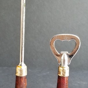 May include: Two miniature glass bottles shaped like liquor bottles with silver bottle openers attached. The bottles are brown and have labels that read "Johnnie Walker Red Label Old Scotch Whisky".