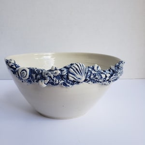 Ivory Colored Pottery Bowl with Blue and White Embossed Seashell and Rock Detail - Signed