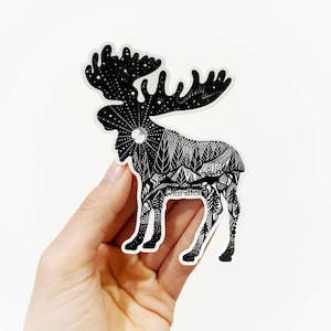 May include: Black and white sticker of a moose with a detailed design of a forest scene inside its silhouette. The sticker has the text "Wild Slice" on the moose's body.