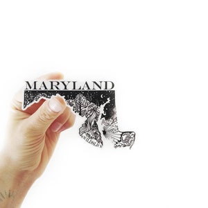 May include: A black and white sticker of the state of Maryland with a detailed illustration of the state's landscape and the word "WILD SLICE" at the bottom. The sticker has the word "MARYLAND" at the top.