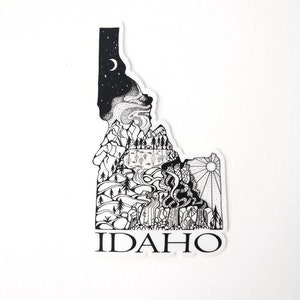 May include: Black and white line art sticker of the state of Idaho with a mountain scene and the word "IDAHO" at the bottom.