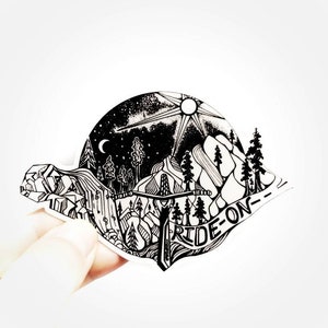May include: Black and white sticker featuring a mountain scene, trees, a sun, a moon, and the text "RIDE-ON".
