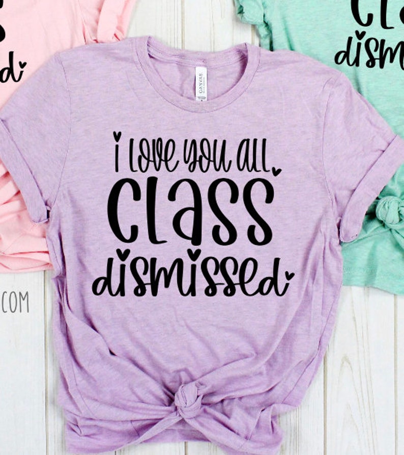 May include: A lavender t-shirt with the text "I love you all. Class dismissed." in black lettering with hearts.