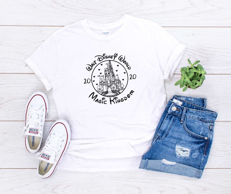 May include: White t-shirt with a black and white graphic of Cinderella's castle with the text "Walt Disney World 2020 Magic Kingdom 20" in a circle around the castle.