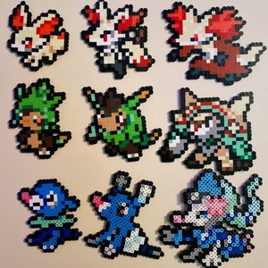 May include: A collection of eight pixel art Pokemon characters, including Vulpix, Growlithe, and a few others. The characters are made of colorful beads and are arranged in a grid pattern.