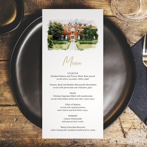 May include: A wedding menu card featuring a watercolour illustration of a grand house. The menu, written in gold script, details starter, main, and dessert courses. The card rests on a black plate.