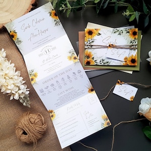 May include: A tri-fold wedding invitation featuring a sunflower and foliage design. The invitation includes the names Sarah Coleman and Alex Harper, the date 11 December 2024, and the time 3 p.m. at St. Jude's Church. The invitation also includes an order of the day and a gift wish list.