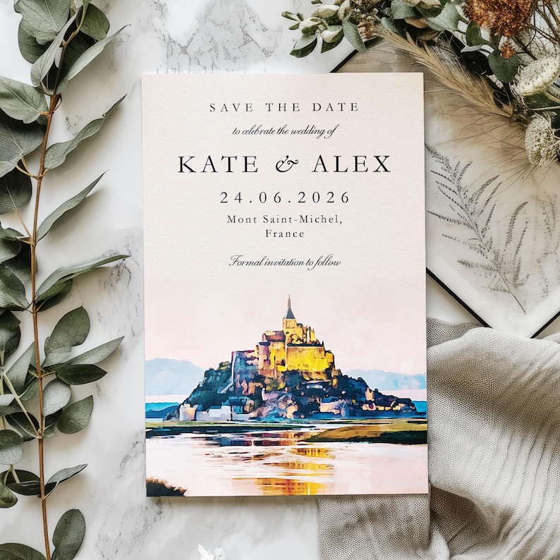 May include: A wedding invitation card with the text "SAVE THE DATE" and the names "KATE & ALEX". The card features a watercolour painting of Mont Saint-Michel, France, with the date 24.06.2026.