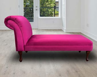 May include: A bright pink chaise lounge with a curved back and wooden legs. The chaise lounge is sitting on a light wood floor.