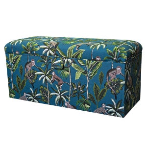 May include: A teal blue storage ottoman with a tropical print featuring monkeys and palm trees.