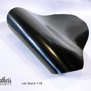 May include: A close-up of a black leather sheet, showing its smooth, shiny surface. The text "col. black #10" is visible in the lower right corner.