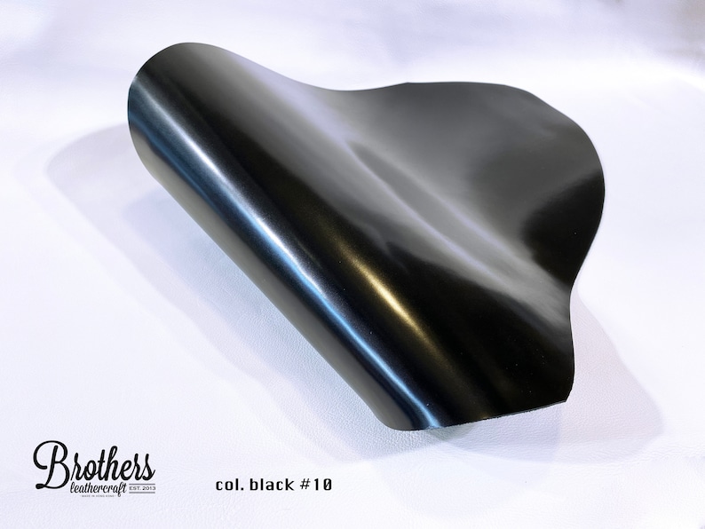 May include: A close-up of a black leather sheet, showing its smooth, shiny surface. The text "col. black #10" is visible in the lower right corner.