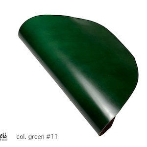 May include: A close-up of a dark green leather sheet, rolled up and showing its smooth, glossy surface. The text "col. green #1" is visible in the lower left corner.