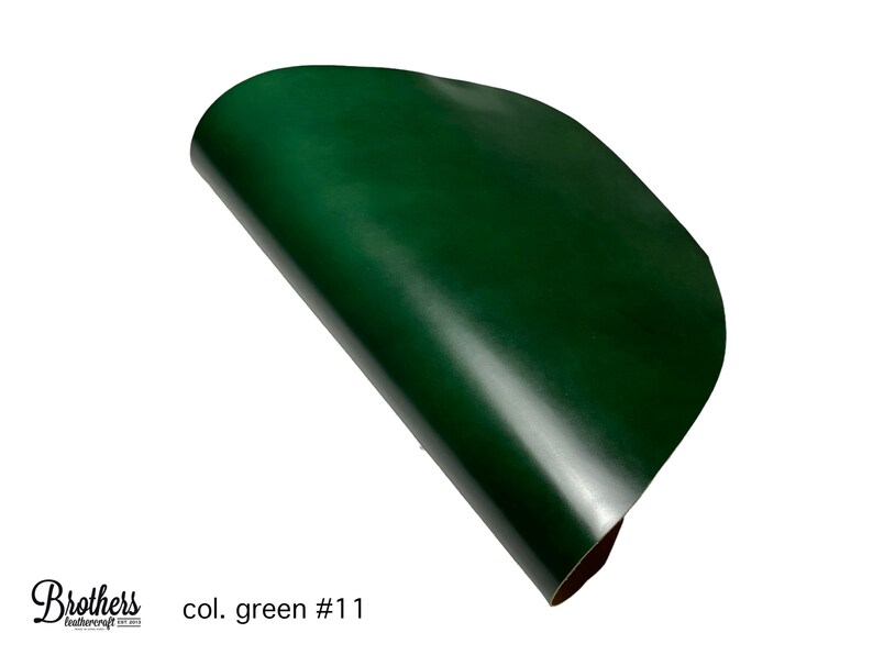 May include: A close-up of a dark green leather sheet, rolled up and showing its smooth, glossy surface. The text "col. green #1" is visible in the lower left corner.