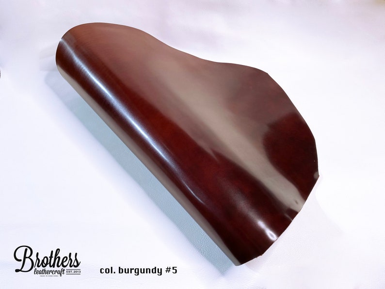 May include: A close-up of a burgundy leather sheet, rolled up and showing its smooth, glossy surface. The text "col. burgundy #5" is visible in the lower right corner.