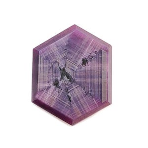 May include: A hexagonal cut gemstone featuring a deep purple and magenta colour palette with a distinct star-like pattern radiating from the centre. The stone displays visible internal inclusions and linear growth lines across its flat surface.