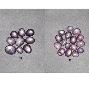 Puede incluir: Dos grupos de gemas ovaladas sobre un fondo gris. Las gemas son de tonos morados y grises, con un efecto de estrella visible en algunas. Los textos "S1" y "S2" están debajo. La parte superior de la imagen contiene el texto "SAKSHAM GEMS THE EFFICACY".