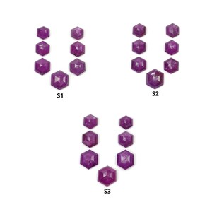 May include: Three sets of faceted, hexagonal gemstones in varying sizes, arranged on a white surface. The gems are a deep, rich purple color. Each set is labeled with a white text: S1, S2, and S3.
