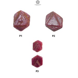 May include: Three red ruby gemstones, each with a hexagonal shape and a faceted surface. The gemstones are labeled P1, P2, and P3.