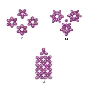 Puede incluir: Tres arreglos diferentes de piedras preciosas ovaladas de color rosa. La primera disposición es una forma de flor etiquetada como L1. La segunda disposición es una forma de flor etiquetada como L2. La tercera disposición es una forma de línea vertical etiquetada como L3.