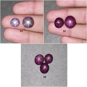 May include: Three sets of star ruby gemstones. The first set has two stones, one is a light purple and the other is a darker purple. The second set has two red stones. The third set has three red stones.