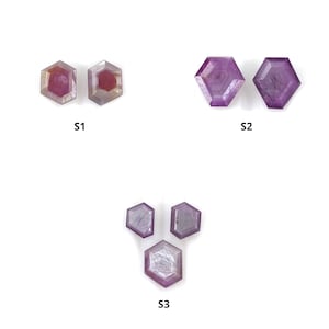 Puede incluir: Tres conjuntos de gemas facetadas en forma hexagonal. Las gemas son en tonos de púrpura y rosa, con estructuras internas visibles. Los conjuntos están etiquetados como S1, S2 y S3.