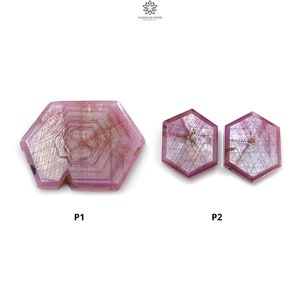 May include: Three pink gemstones with a hexagonal shape are shown against a white background. The largest stone has a unique cut with a central design. The other two stones are smaller and have a similar shape. The gemstones are labelled P1 and P2.