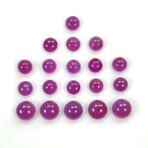 May include: A collection of fourteen smooth, spherical beads in a vibrant magenta-purple color. The beads are arranged in a triangular formation, with one bead at the top, followed by rows of three, five, and five beads, all featuring a glossy finish.
