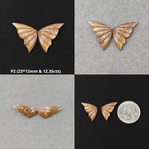 May include: Two pairs of iridescent butterfly-shaped sunstone cabochons. The cabochons are a light peach color with a shimmery finish. The cabochons are approximately 23mm by 12mm and weigh 12.35 carats.