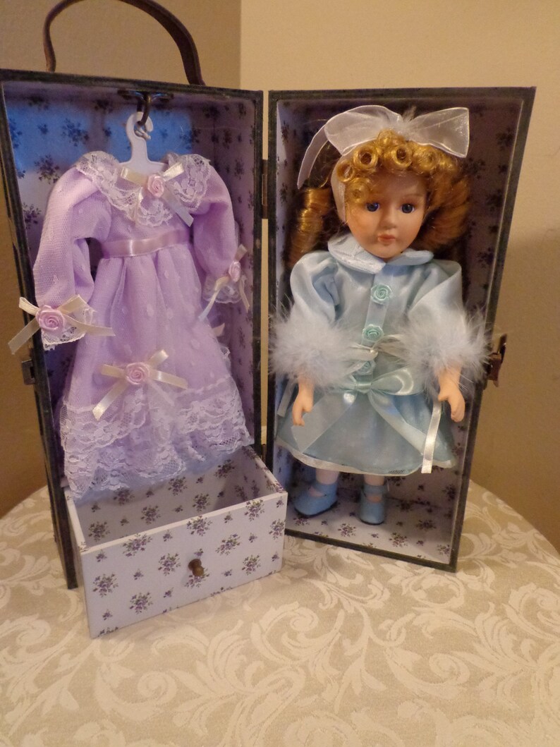 porcelain doll in wooden box