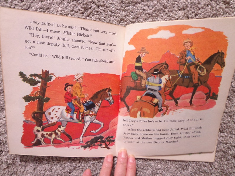 May include: Illustration from a vintage children's book, showing cowboys riding horses in a desert setting. The image includes cowboys, horses, and a dog, with text from the story visible.