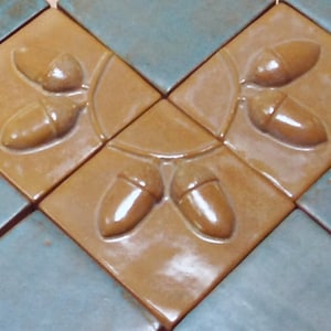 Set of three, 3" Acorn tile, ocher glaze.