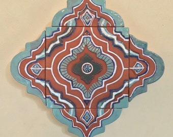 Tile Wall hanging with turquoise and white on  rich terracotta.