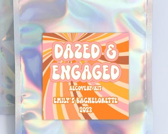 May include: A silver iridescent zippered pouch with a colorful sticker that says "Dazed & Engaged Recovery Kit Emily's Bachelorette 2023".