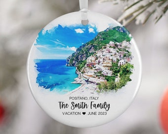 May include: Round white ceramic ornament with a watercolor image of Positano, Italy. The text "The Smith Family Vacation June 2023" is printed on the ornament.