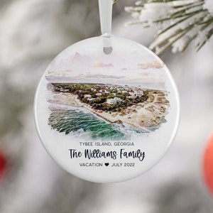 May include: White round ceramic ornament with a watercolor image of Tybee Island, Georgia. The text "The Williams Family Vacation July 2022" is printed on the ornament.