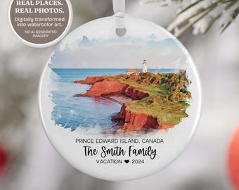 May include: A round white ceramic ornament featuring a watercolor-style coastal landscape with a lighthouse, red cliffs, and blue water. Text reads: PRINCE EDWARD ISLAND, CANADA, The Smith Family, VACATION 2024. It hangs from a white ribbon.