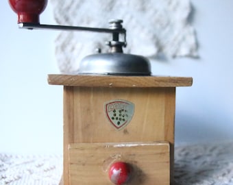 Antique wooden coffee grinder, with red knob, used
