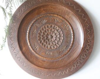 Medium size vintage engraved wooden plate, round dark wood plate