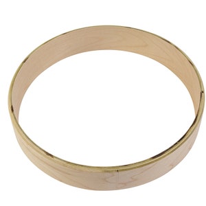May include: A wooden hoop for a drum, made of light brown wood.