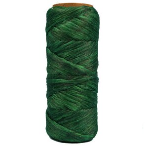 May include: A spool of dark green twine, perfect for crafts, gardening, or wrapping gifts.